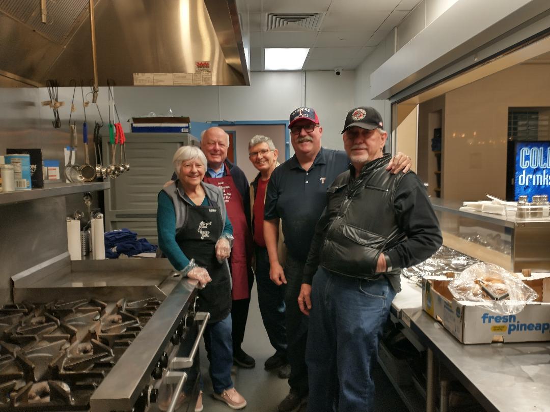 Members of the Men's club serving food at the Arlington Life Shelter