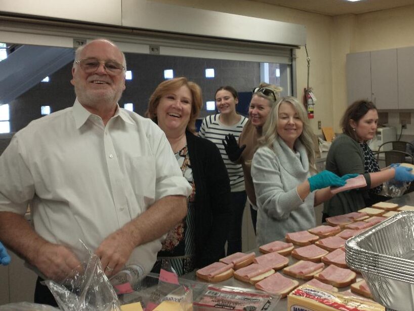 Members of the Men's Cub preparing food to be served at the Arlington Life Shelter