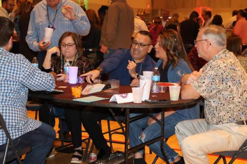 Guests playing table games at the Mardi Gras Casino party. 