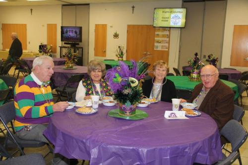 A table of guests at the Mardi Gras party