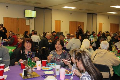 Guests eating at the Mardi Gras party