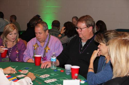 Guests playing table games at the Mardi Gras Casino party. 
