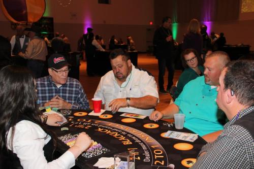 Guests playing table games at the Mardi Gras Casino party. 